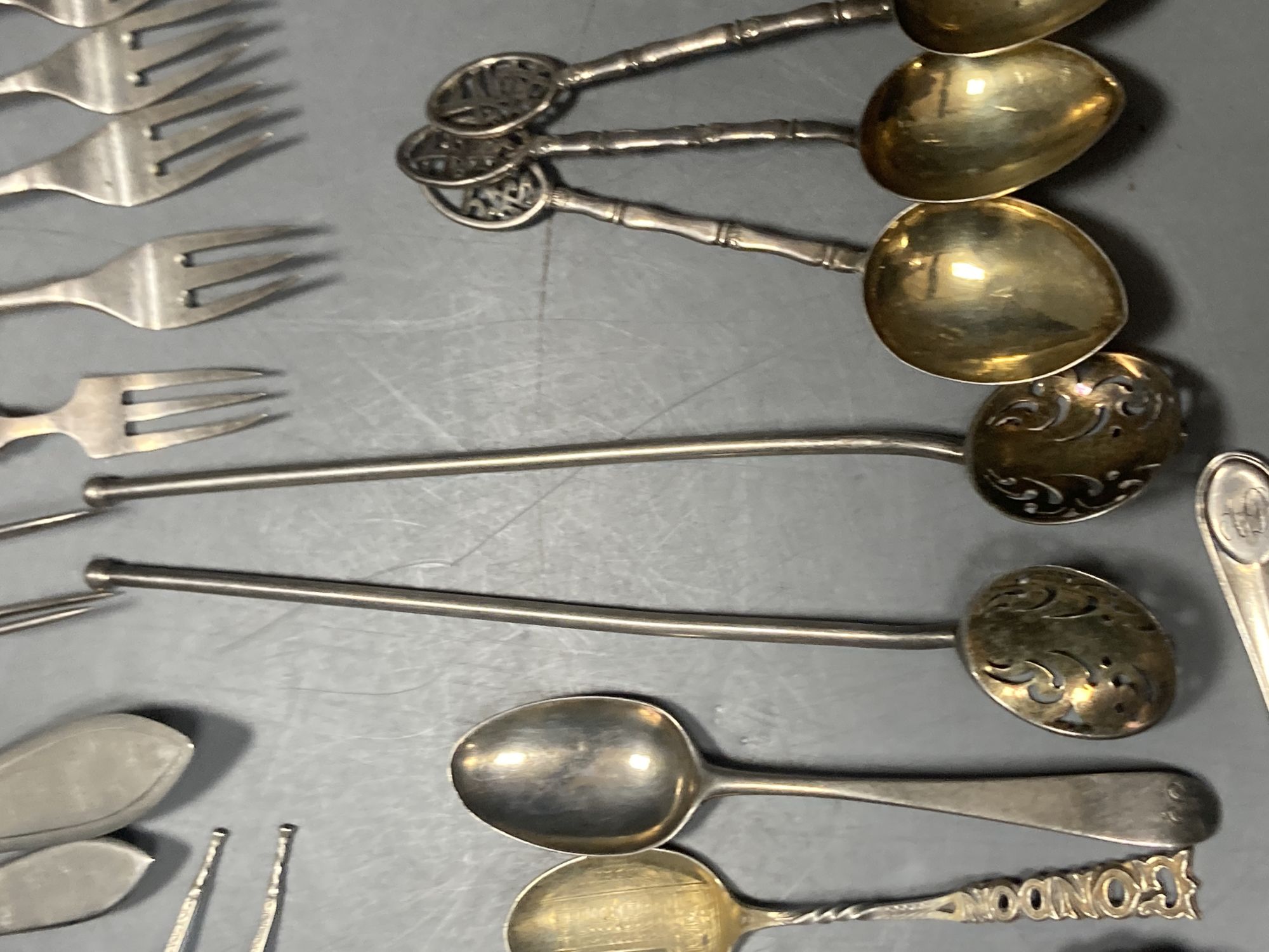 A group of assorted Chinese white metal spoons and forks, including set of six teaspoons and ten small items of English silver.